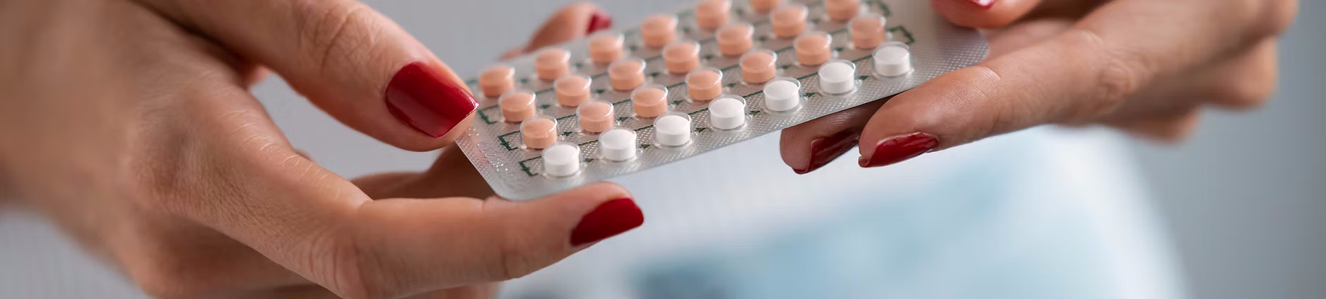 Hands holding medications.